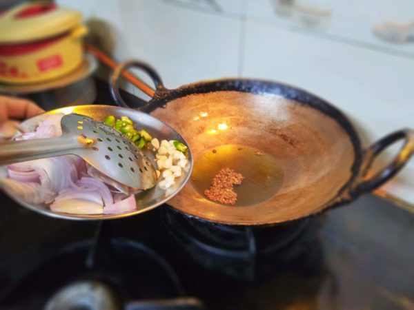 Heat Oil and add Jeera, Garlic, Hing, Green Chilli and Onions. Saute all ingredients until Onion become transparent.